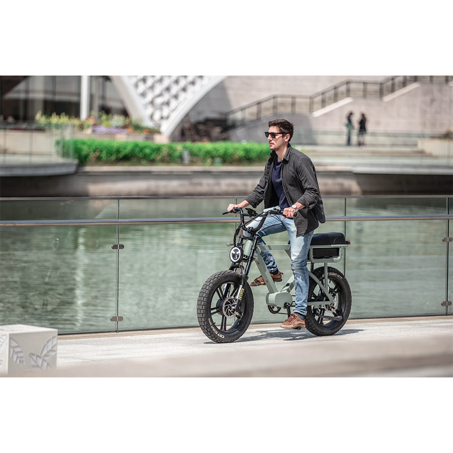 Person riding Eunorau Flash e-bike by water