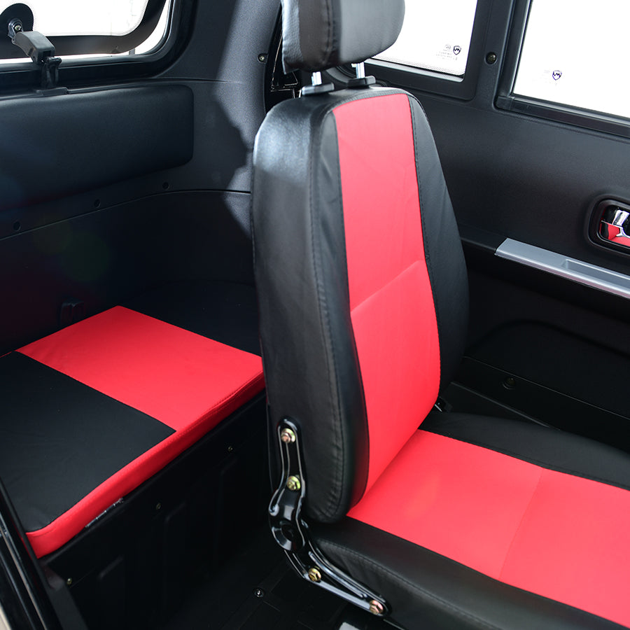 Interior of compact electric vehicle, red and black seats