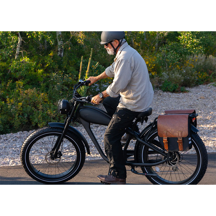 Black variant with a man riding it and saddle bag on the back