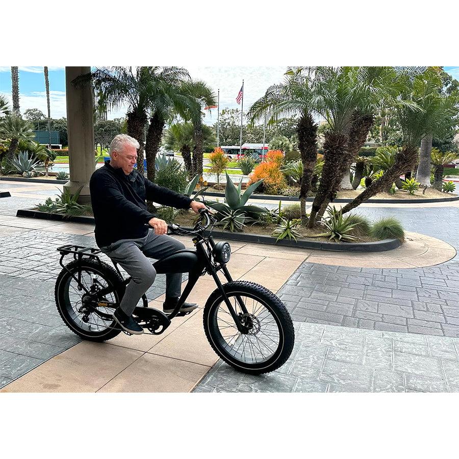 Man riding the black variant with saddle bag