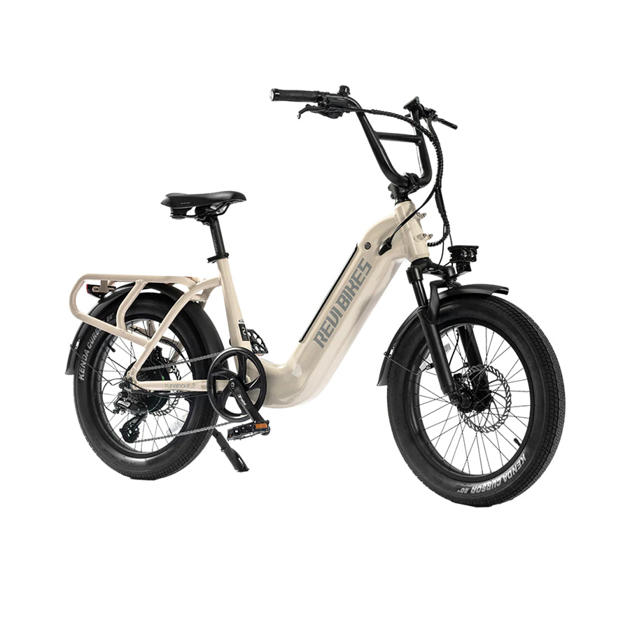Cream Revi Bikes Runabout 2.0, 750W electric bike with hydraulic brakes, angled view.